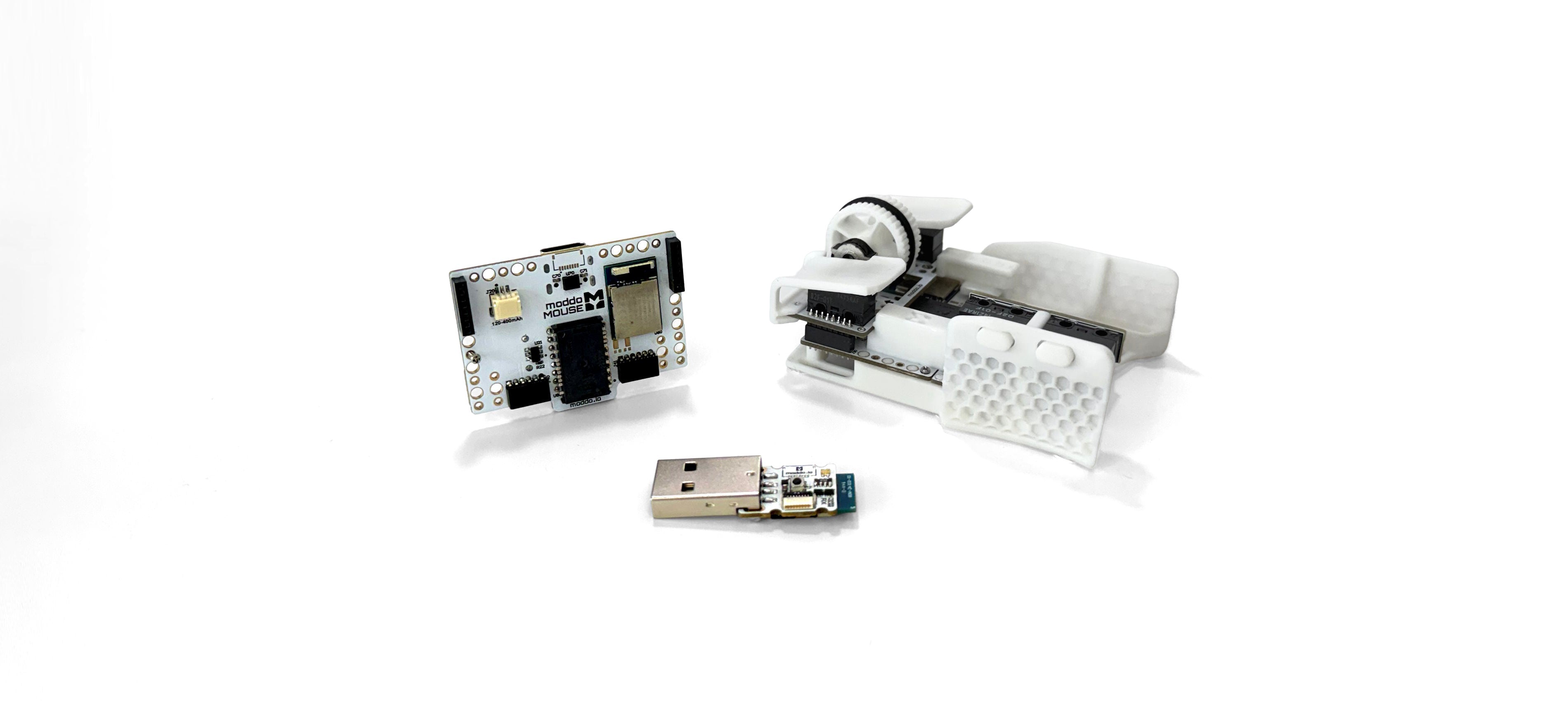 moddoMOUSE V1 kit with its main board, wireless receiver, and assembled mouse