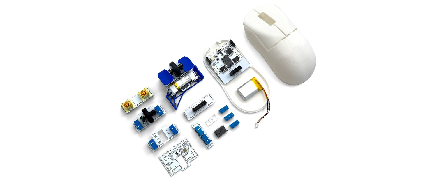 The moddoMOUSE disassembled into its modular boards, switches, battery, and shell